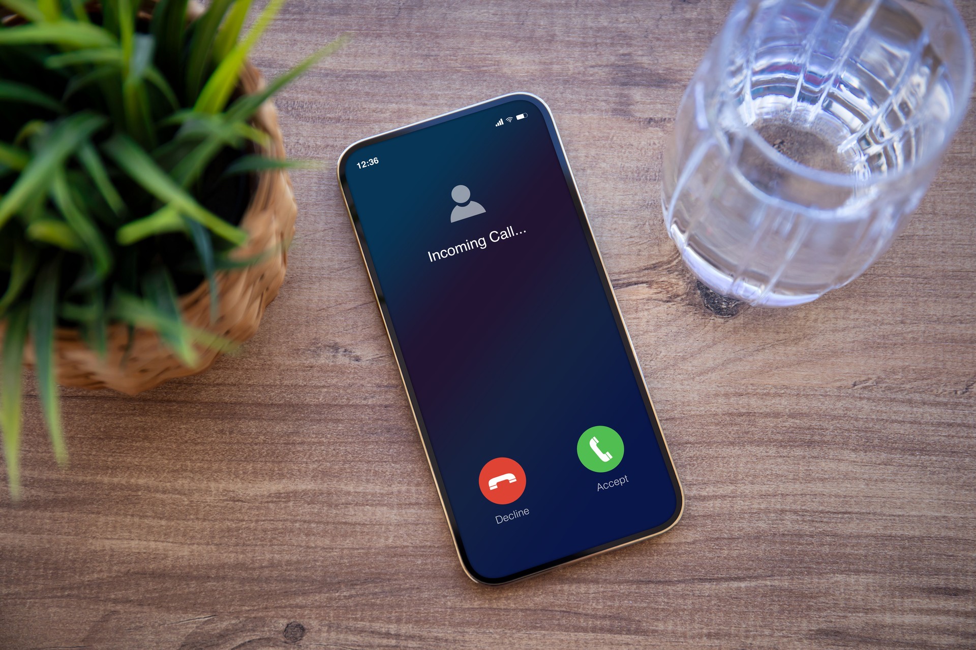 phone with incoming call on screen background of wooden table